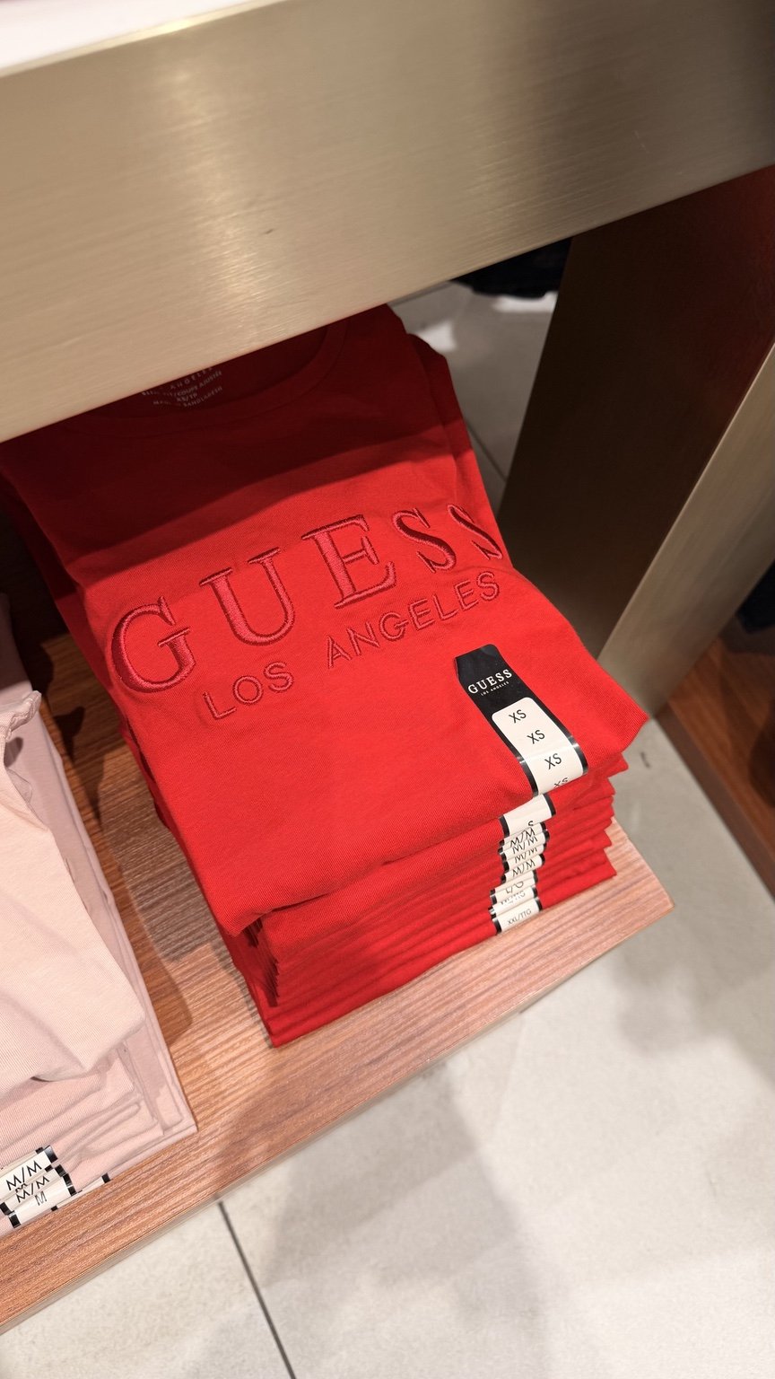 Red tonal GUESS tee · shelf view