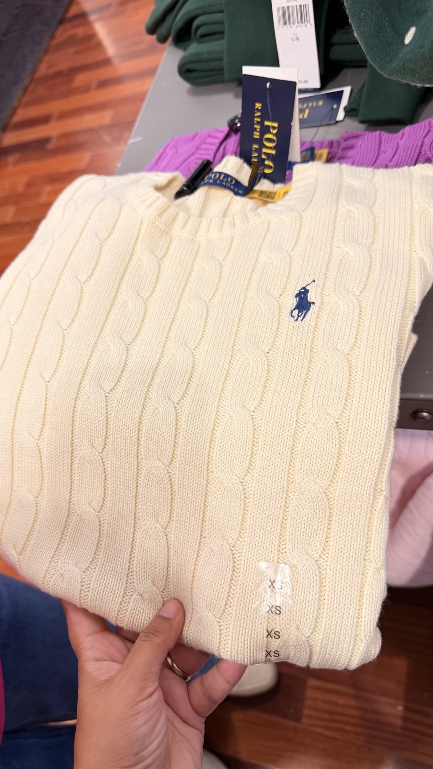 Ivory cable-knit sweater · blue emblem