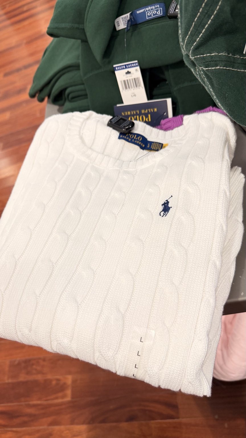 Ivory cable-knit sweater · folded view