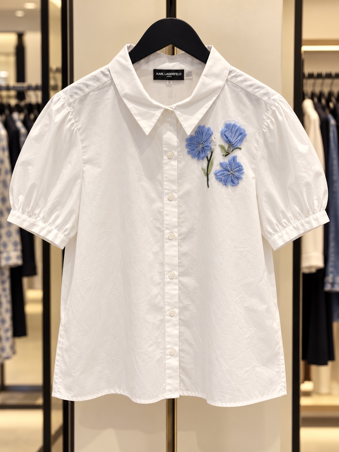 White short-sleeve shirt with blue floral embroidery